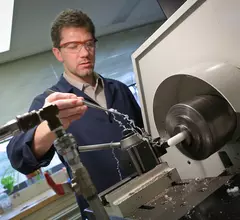 Machinist Patrick Leibich of Penn State College of Medicine’s division of Applied Biomedical Engineering works to create artificial heart parts. Image courtesy of Penn State.